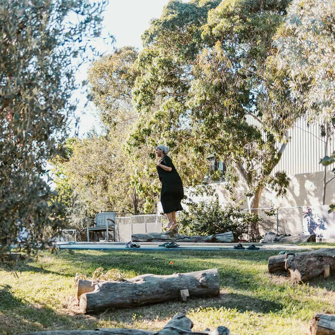 Outdoor community space at The Venny with children playing and nature.