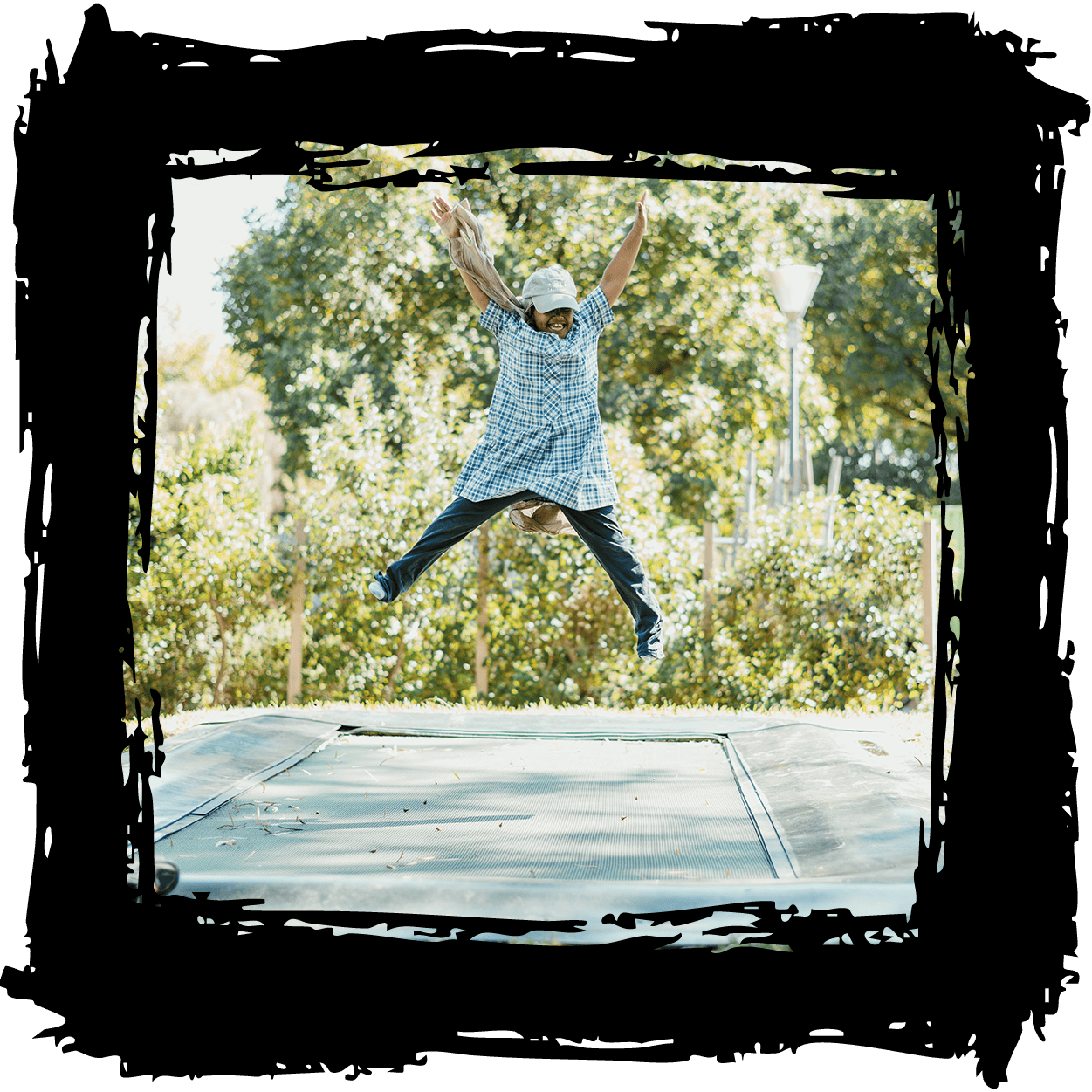 Child jumping on trampoline at The Venny, an outdoor play space for children’s fun and activity.