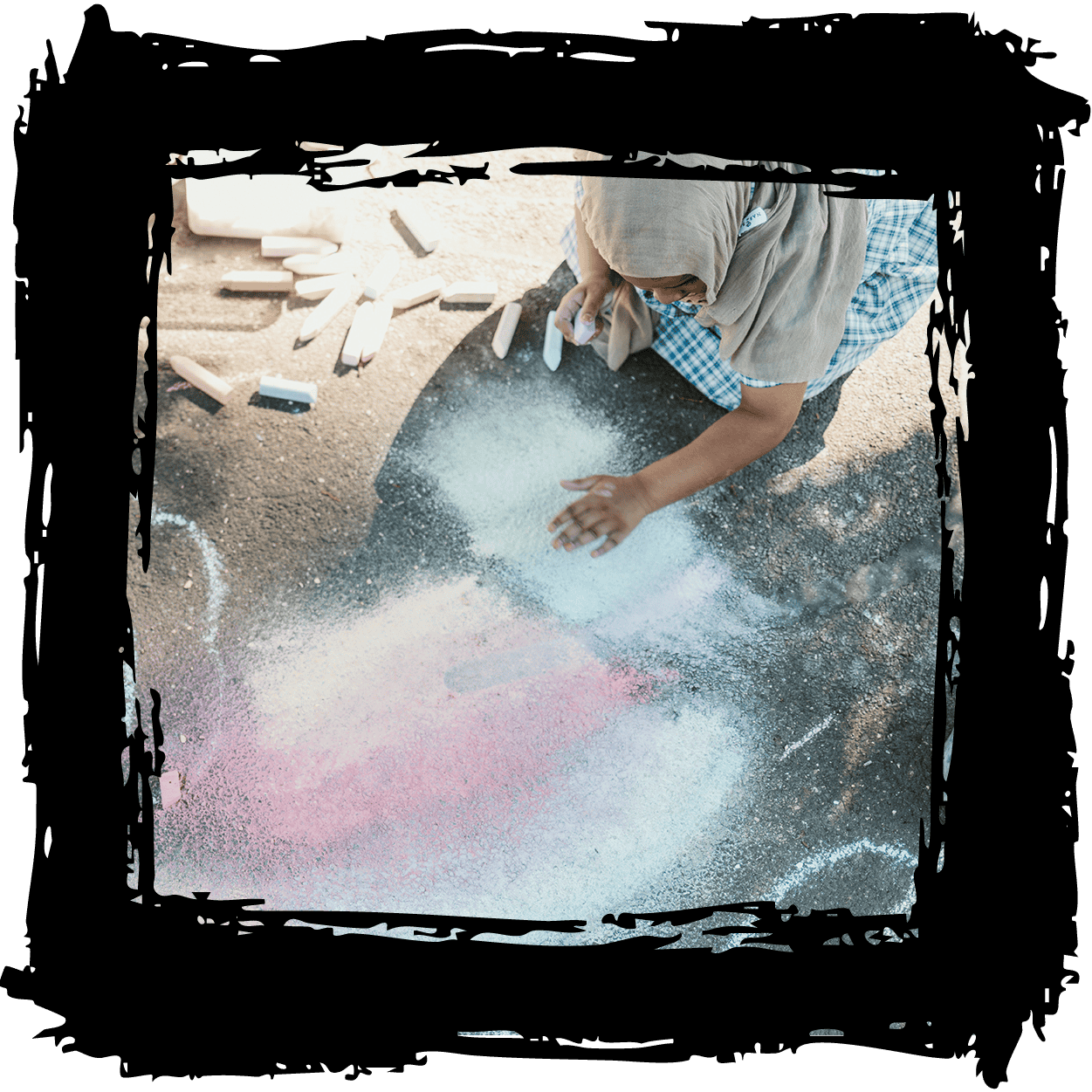 Children playing with colorful chalk and sand at The Venny community space in Melbourne.