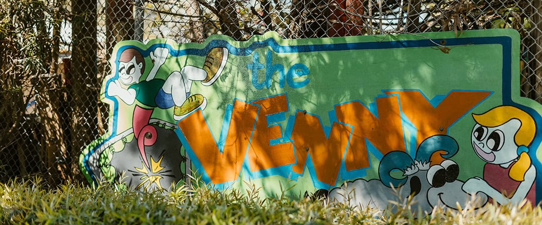 Venny Community Garden Entrance Colorful sign for The Venny community garden with cartoon characters and vibrant lettering.
