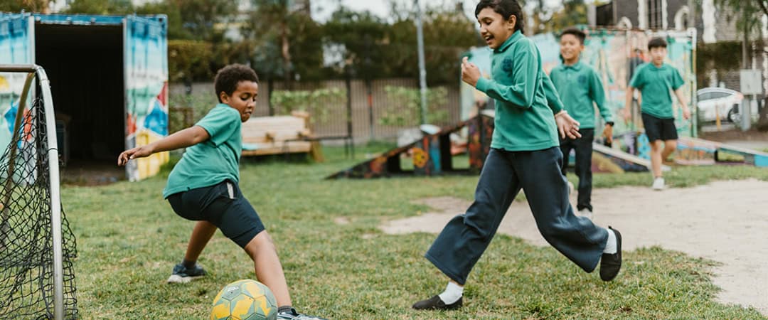 Children playing soccer at The Venny community farm and play area.