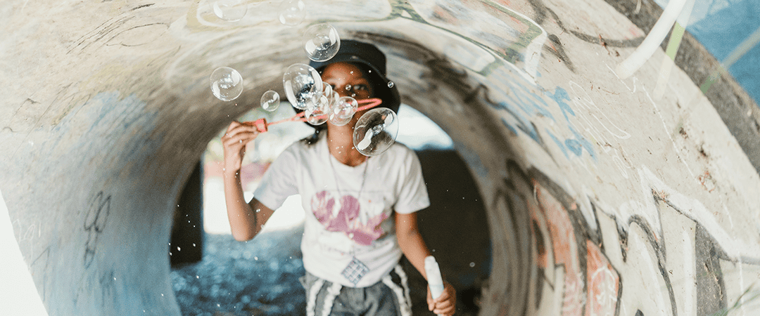 Child playing with bubbles at The Venny community playground.